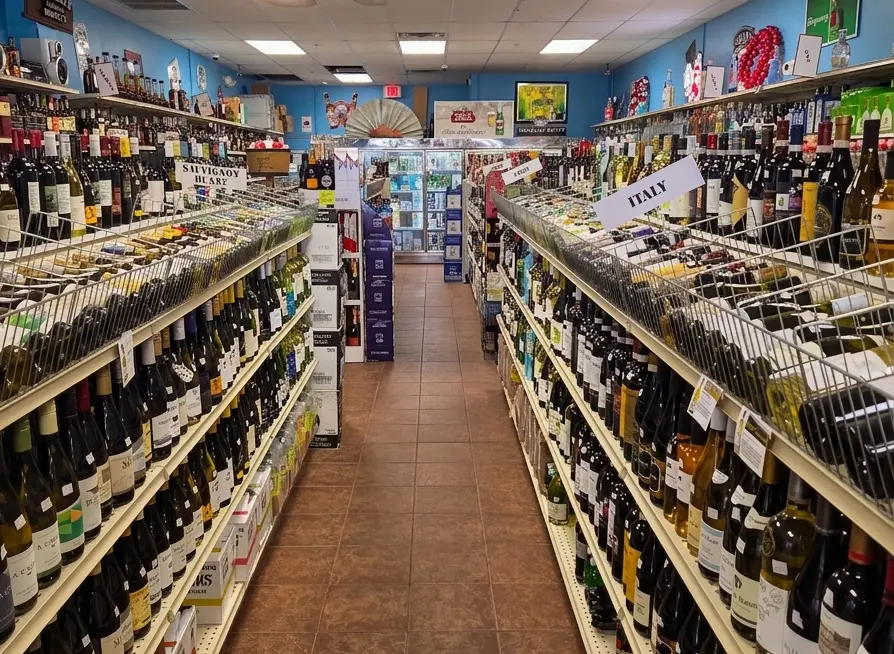 Wine bottles lined up on shelves along the store aisle